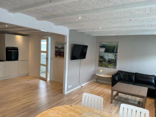 a living room with a couch and a table at New apartment in the middle of Klaksvík in Klaksvík