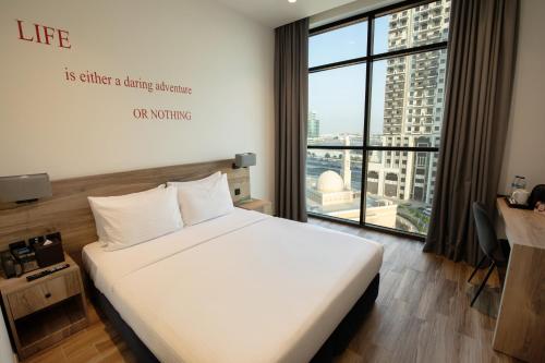 Katil atau katil-katil dalam bilik di Kingsgate Al Jaddaf Hotel by Millennium