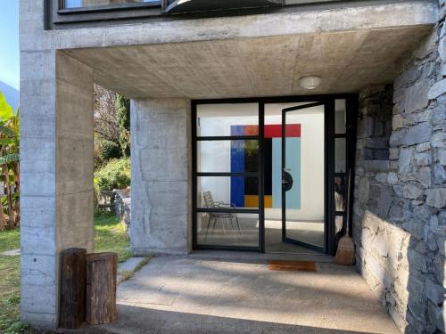 a pivot door in a stone house with a window at B1Verscio Villa Cavalli in Verscio