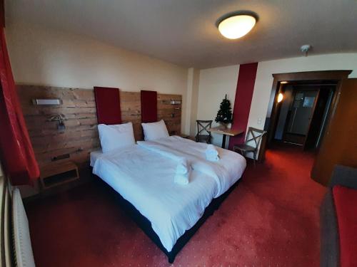En eller flere senge i et værelse på Hotel Buckelhof