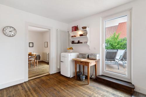 a kitchen with a refrigerator and a table and a window at Ferienhaus am Künstleratelier in Riegel