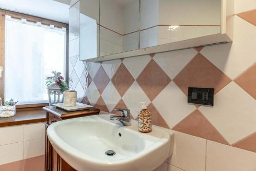 a bathroom with a sink and a mirror at Al Borgo, Taio Ospitar in Taio