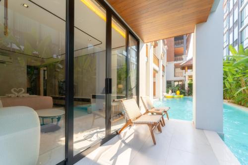 an external view of a house with a swimming pool at Verbena Chiangmai in Chiang Mai