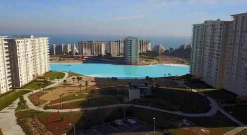 a large swimming pool in a city with tall buildings at Laguna Bahía Mar y Campo in San Antonio