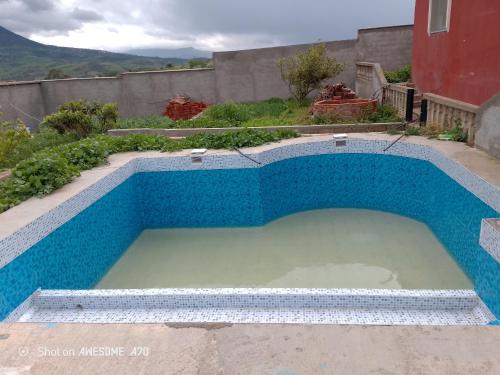 a large pool of water in a yard at دار الضيافه امال in Tetouan