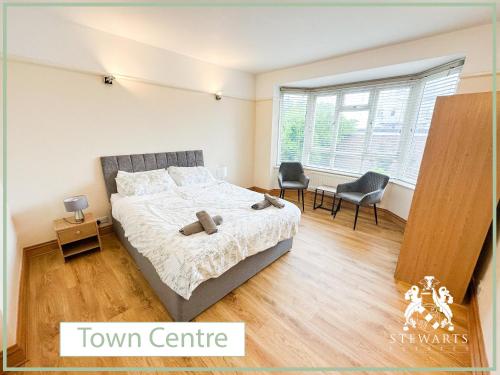a bedroom with a bed with a teddy bear on it at Town Centre Apartment Sleeps 9 in Bournemouth