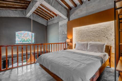 een slaapkamer met een bed en een bakstenen muur bij Marjoram Otel in Sile