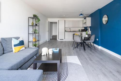 a living room with a couch and a table at Indigo Heaven at Hemel in Hemel Hempstead