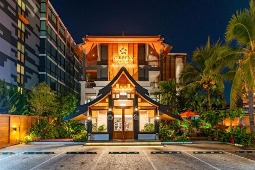 a building in front of a hotel at night at Verbena Chiangmai in Chiang Mai