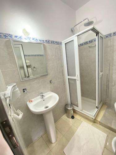 a bathroom with a sink and a shower at Hotel Chaouen in Chefchaouene