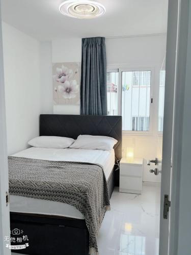 a bedroom with a bed and a window at San Eugenio in Adeje