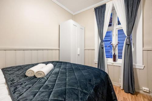 a bedroom with a bed with two pillows and a window at Kong Oscars gate 28 - 302 in Bergen