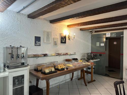 a kitchen with a table with food on it at Hotel Modena - São José dos Campos in São José dos Campos