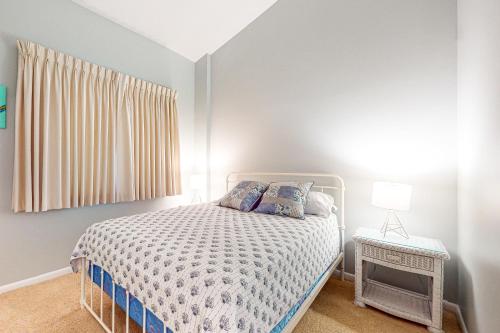 a white bedroom with a bed and a window at Sea Colony - 902 Georgetowne House in Bethany Beach