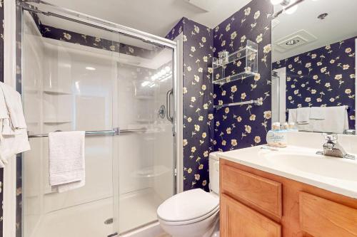 a bathroom with a shower and a toilet and a sink at Sea Colony - 902 Georgetowne House in Bethany Beach