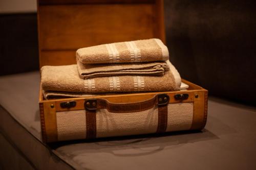 a pile of towels sitting on top of a suitcase at Carmen's cozy&luxury apartment! in Athens