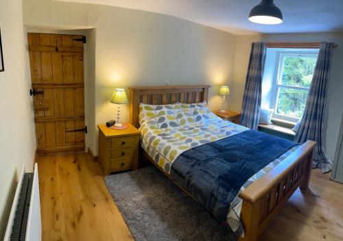 a bedroom with a bed and a window at Moorland View in Cotterdale
