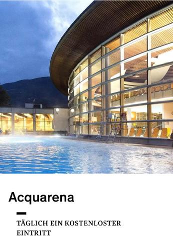 a building with a swimming pool in front of it at Ferienwohnung Burgfrieden Brixen with BrixenCard in Brixen