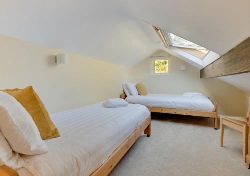 a attic bedroom with two beds and a skylight at Lingmoor Lookout in Chapel Stile