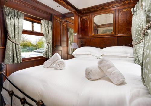 a bedroom with two beds with white pillows at Irt Pullman Carriage in Ravenglass