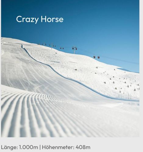 a snow covered slope with tracks in the snow at Ferienwohnung Burgfrieden Brixen with BrixenCard in Brixen