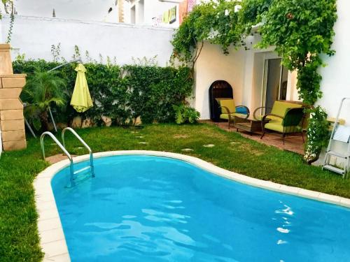 a swimming pool in the yard of a house at 4 bedrooms villa at Dar Bouazza Tamaris 200 m away from the beach with private pool and enclosed garden in Dar Bouazza