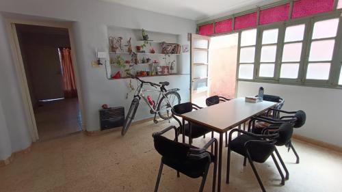 a room with a table and chairs and a bike at Godoy cruz hause in Godoy Cruz