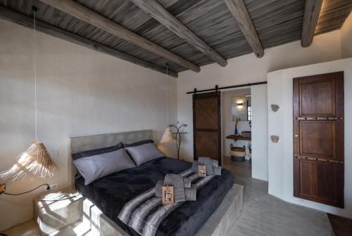 a bedroom with a bed and a wooden ceiling at Finca Luz in Puerto del Rosario