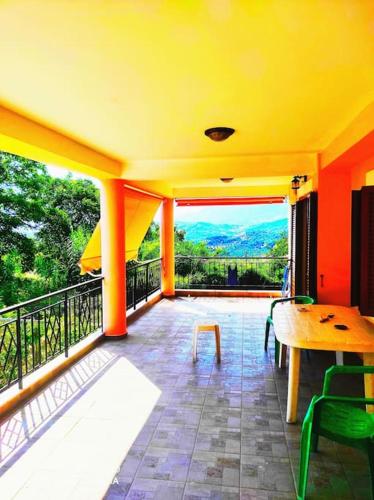 a room with a balcony with a table and chairs at The best view in Zakharo