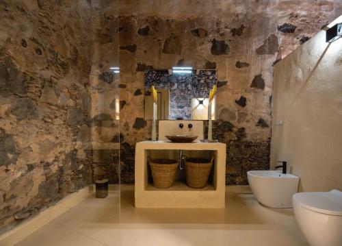 a bathroom with a sink and a toilet at Finca Luz in Puerto del Rosario