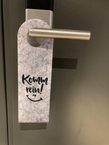 Una toalla en la puerta del baño con la palabra kumkun remix en BergButzen, en Braunlage