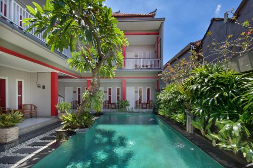 a pool in the courtyard of a villa at Angkul Angkul Beach Inn Kuta by Kamara in Kuta