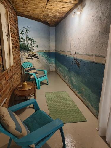 a room with chairs and a painting on the wall at Shangrila-innibos Country Lodge in Hartbeespoort