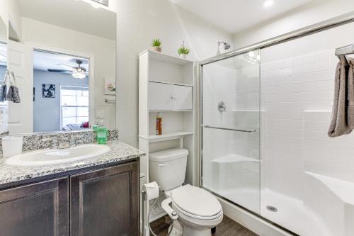 a bathroom with a shower and a toilet and a sink at Stylish Home with Pool Access, 10 Mi to Vegas Strip! in Las Vegas