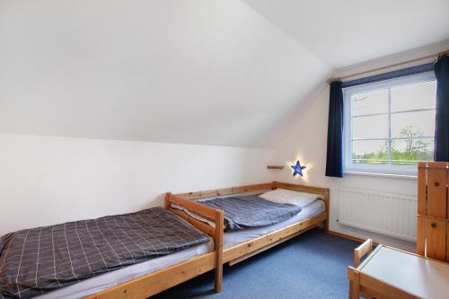 a bedroom with two beds and a window at Ferienwohnung Nico in Langballig