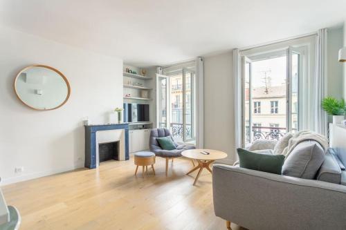 ein Wohnzimmer mit einem Sofa und einem Tisch in der Unterkunft Bastille nest in Paris in Paris