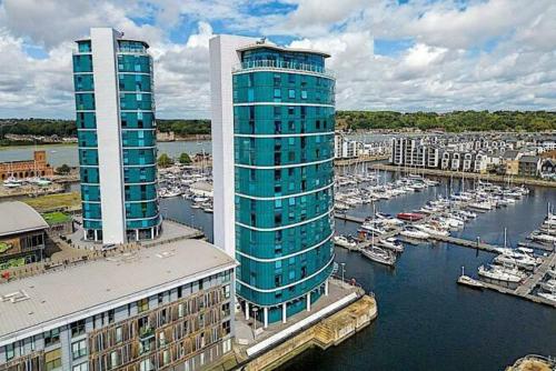 two tall buildings next to a harbor with boats at Heronsgate GH016 in London