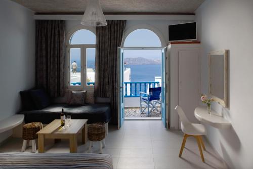 a living room with a view of the ocean at Vallas Apartments & Villas in Firostefani