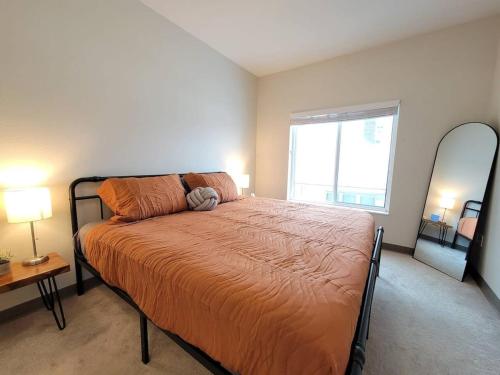 a bedroom with a bed and a large window at Contemporary Living near Mayo in Rochester