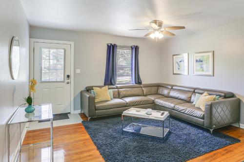 a living room with a couch and a table at Tallahassee Home with Yard Less Than 2 Mi to FSU Campus in Tallahassee