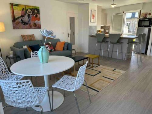 un salon avec une table, des chaises et un canapé dans l'établissement Charmant T2 rénové centre, à Dinard