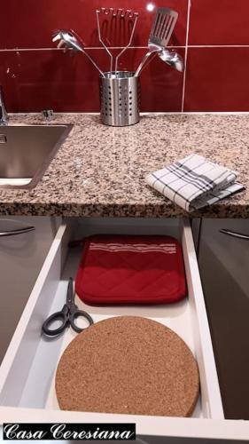 a kitchen with a counter with scissors and a sink at Antica torre del castello Casa Ceresiana in Carabietta