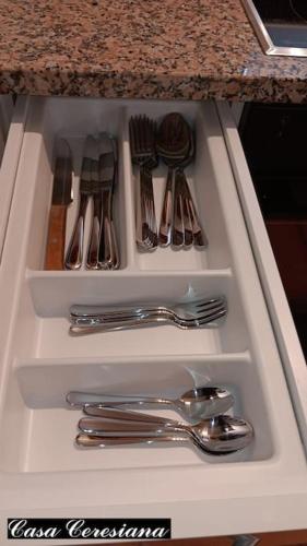 a drawer filled with silver utensils on a counter at Antica torre del castello Casa Ceresiana in Carabietta