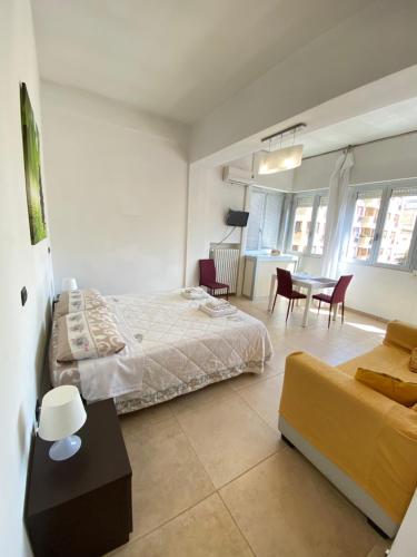 a bedroom with a bed and a table and chairs at Abruzzi 81 in Lecce