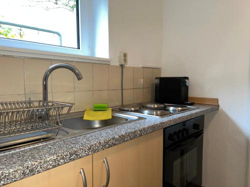 a kitchen with a sink and a counter top at Cosy Appartement Zentral in Cologne