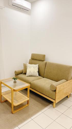 a living room with a couch and a coffee table at MUJI Cosy Level 25th Room Amber Residence @ Quayside Mall Rimbayu Near to Masha Oasis Tenby KLIA Kota Kemuning in Teluk Panglima Garang