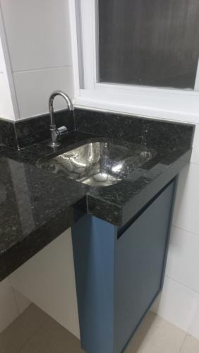 a bathroom counter with a sink and a mirror at Apartamento frente Mar! in Santos