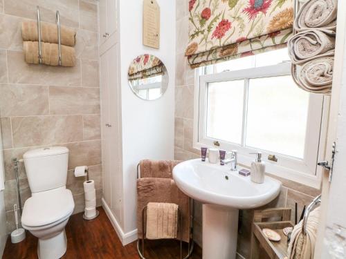 a bathroom with a toilet and a sink at Waters Edge in Bakewell