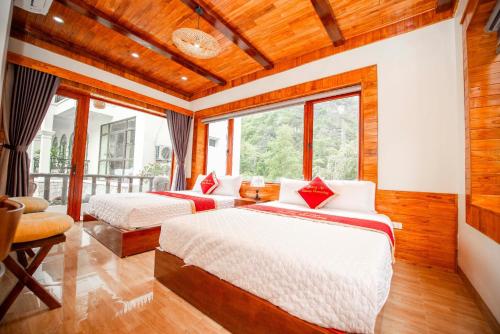a bedroom with two beds and a window at TRANG AN LUXURY HOMESTAY in Ninh Binh