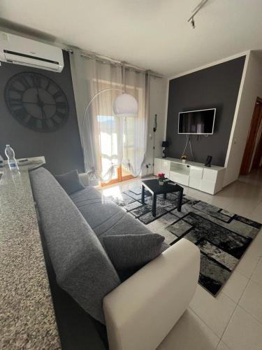 uma sala de estar com um sofá e uma televisão em Casa vacanza Valledoria 2 camere da letto em Valledoria